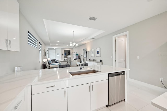 kitchen with dishwasher, a raised ceiling, sink, white cabinets, and a chandelier