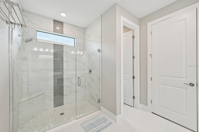 bathroom with tile patterned flooring and walk in shower