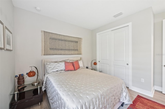 bedroom featuring light wood-type flooring and a closet