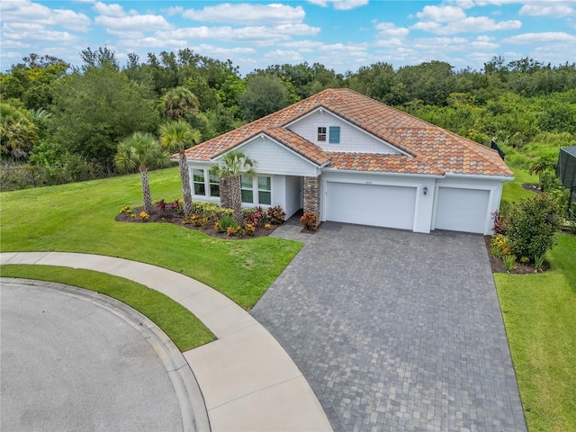 view of front of house featuring a garage and a front lawn