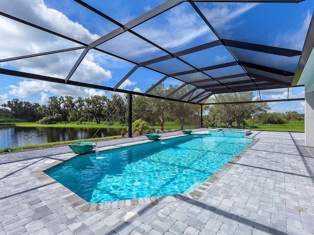 view of pool featuring a lanai, pool water feature, a water view, and a patio