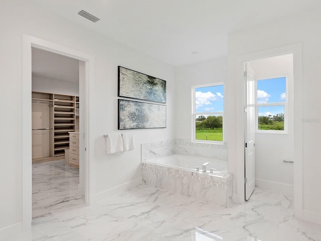 bathroom featuring tiled tub