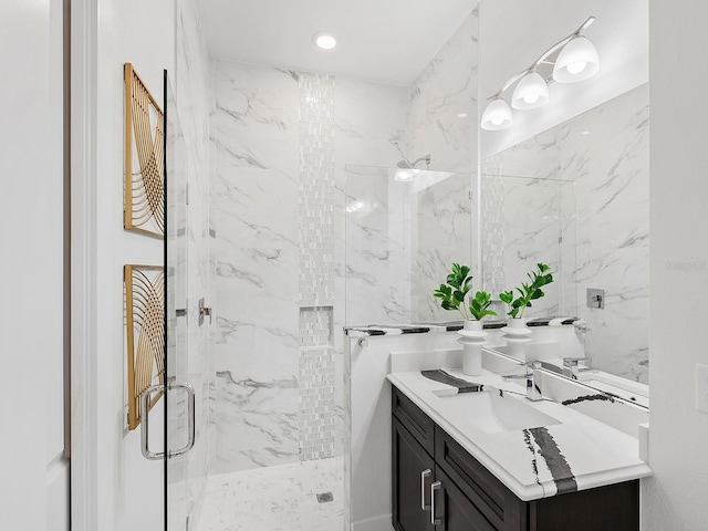 bathroom featuring vanity and a shower with door