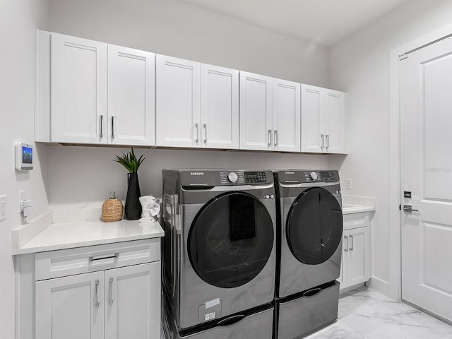 laundry area featuring cabinets and washing machine and dryer