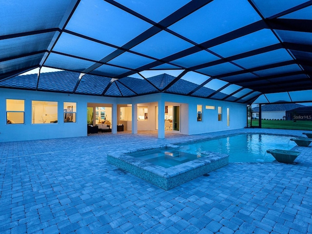 view of swimming pool featuring an in ground hot tub, outdoor lounge area, a patio area, and a lanai