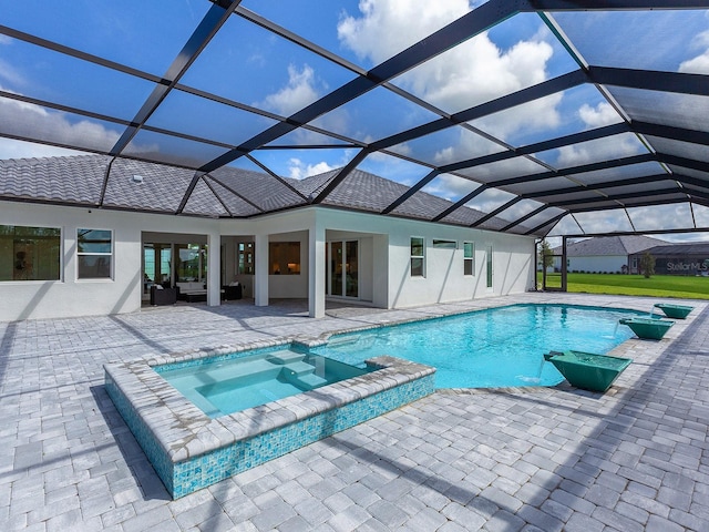 view of pool featuring an in ground hot tub, a patio, and glass enclosure