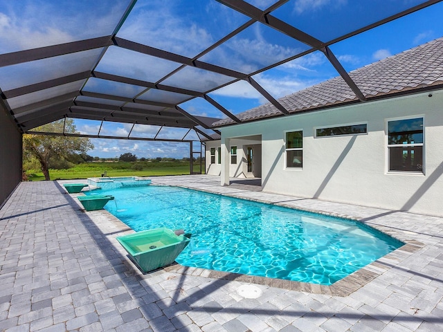 view of swimming pool featuring glass enclosure and a patio area