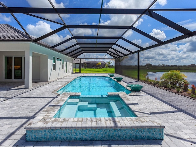 view of swimming pool featuring a lanai, a patio area, a water view, and an in ground hot tub