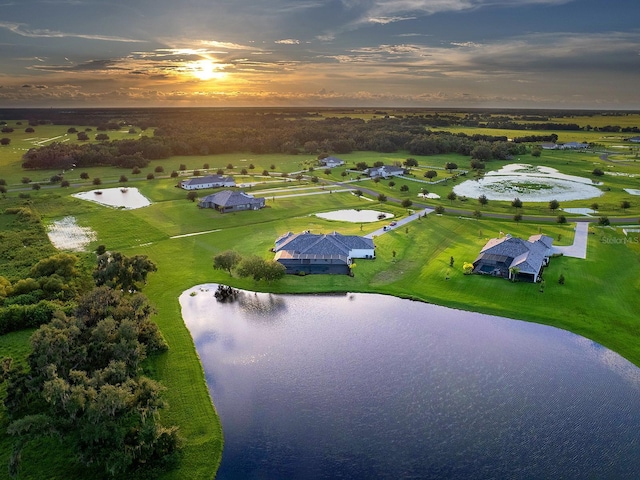 aerial view at dusk with a water view