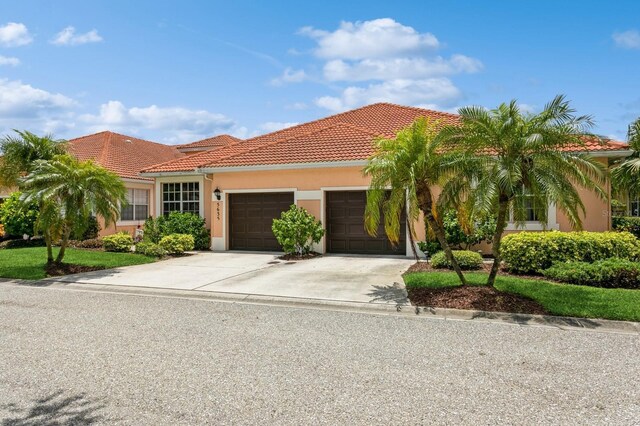 mediterranean / spanish-style house with a garage