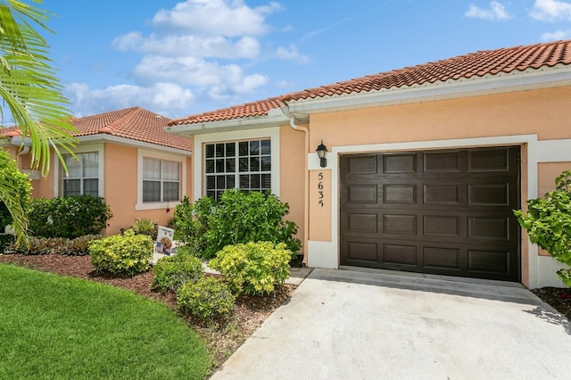 mediterranean / spanish-style home with a garage