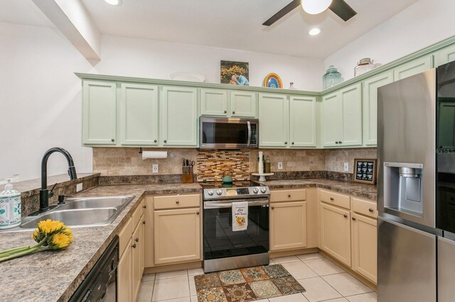 kitchen with light tile patterned floors, appliances with stainless steel finishes, sink, and ceiling fan