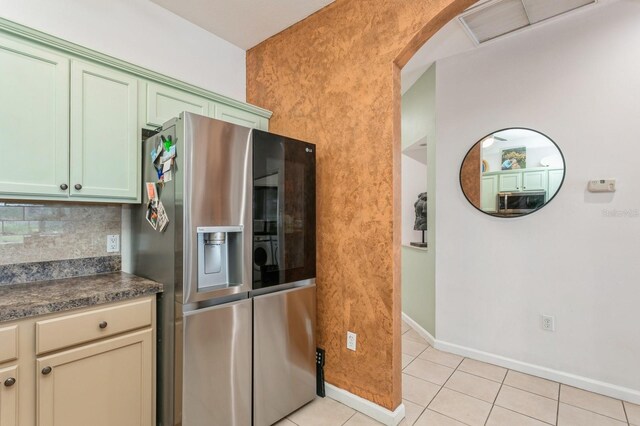 kitchen with light tile patterned floors, tasteful backsplash, and stainless steel fridge with ice dispenser