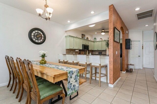 dining space featuring light tile patterned floors and a chandelier