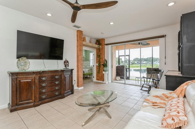 tiled living room with ceiling fan