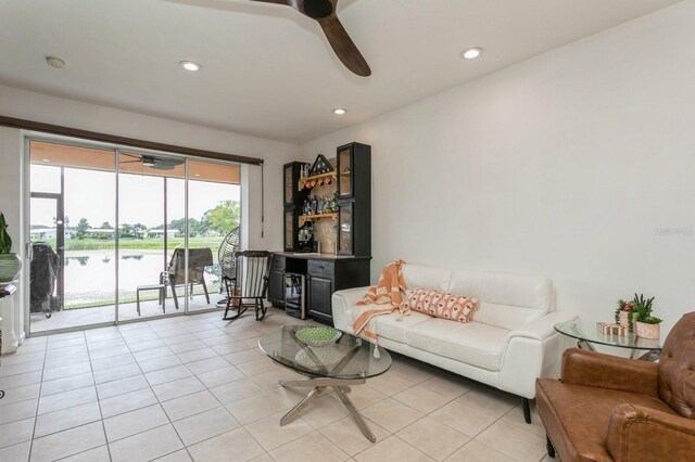 living room featuring ceiling fan and light tile patterned floors