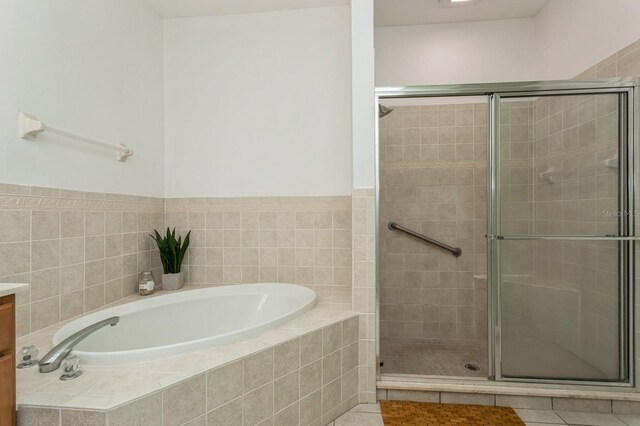 bathroom featuring tile patterned floors, vanity, and separate shower and tub