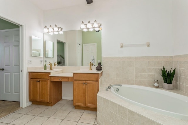 bathroom with tiled bath, tile patterned flooring, and dual bowl vanity