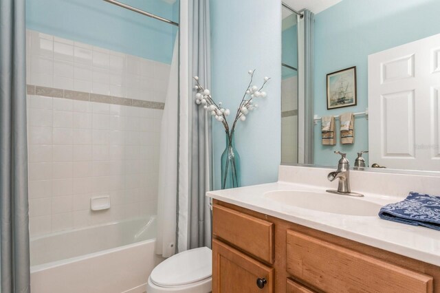 full bathroom featuring shower / bath combo with shower curtain, vanity, and toilet