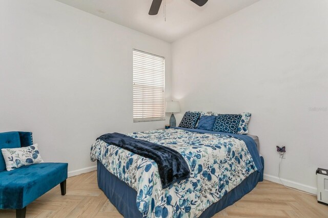 bedroom featuring ceiling fan and parquet flooring