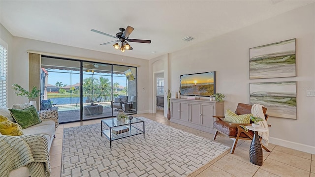 living room with light tile patterned floors and ceiling fan