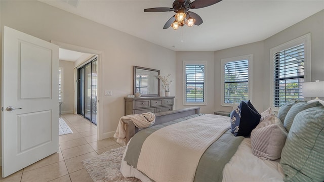 tiled bedroom featuring ceiling fan