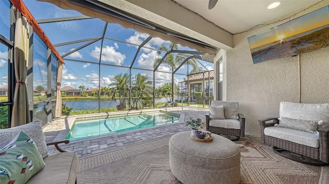 view of patio featuring a lanai and a water view