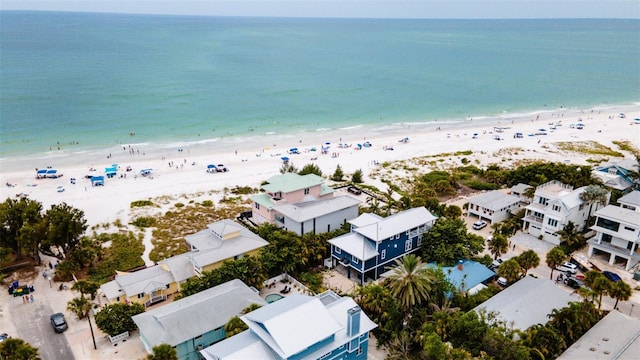 drone / aerial view featuring a water view and a beach view