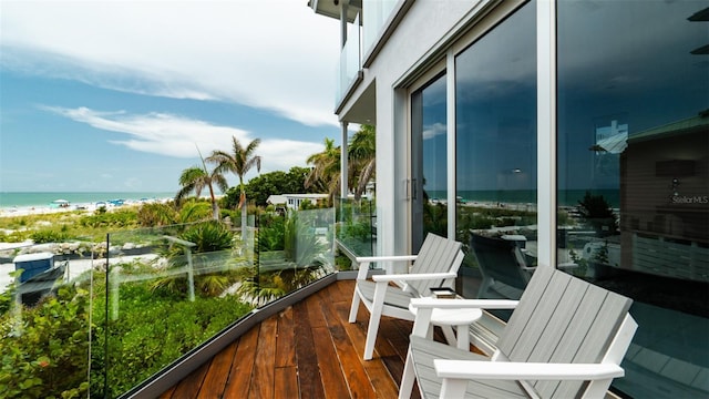 balcony with a water view and a beach view