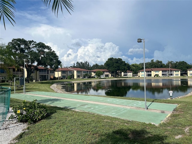 view of home's community featuring a yard and a water view