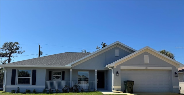 ranch-style home with roof with shingles, stucco siding, a porch, concrete driveway, and a garage