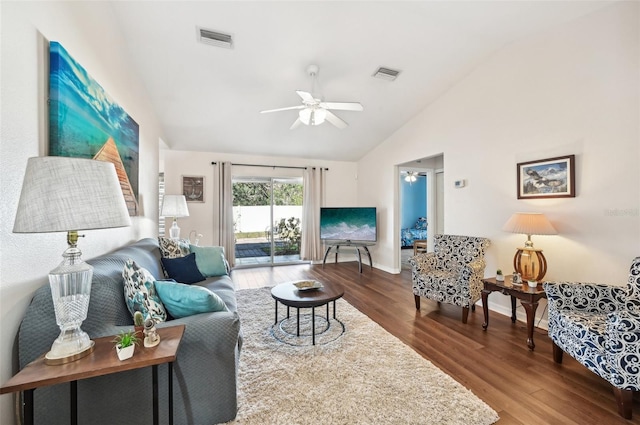 living room featuring hardwood / wood-style floors, vaulted ceiling, and ceiling fan