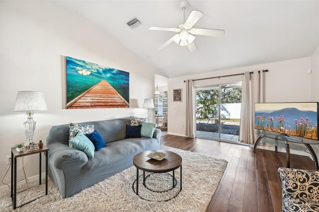 living room with ceiling fan, dark hardwood / wood-style flooring, and vaulted ceiling