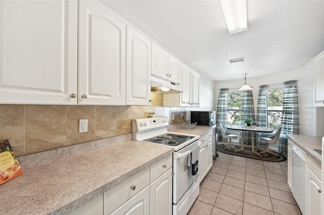 kitchen featuring decorative backsplash, white appliances, light tile patterned floors, decorative light fixtures, and white cabinets