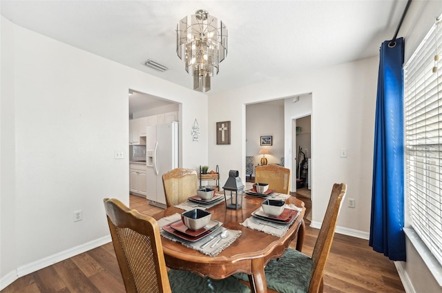 dining room featuring hardwood / wood-style floors and a notable chandelier