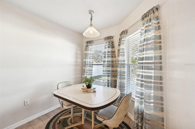 dining space featuring light tile patterned floors