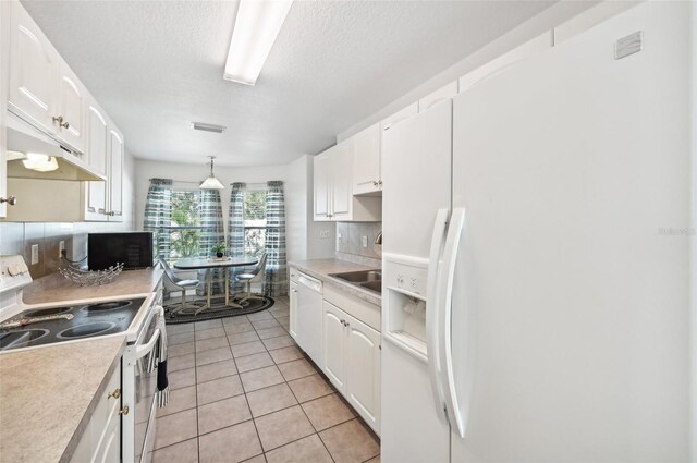 kitchen featuring decorative light fixtures, white cabinetry, white appliances, and tasteful backsplash