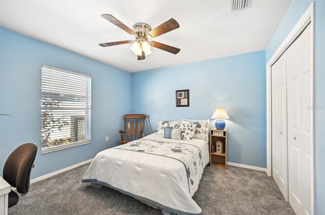 carpeted bedroom with ceiling fan and a closet