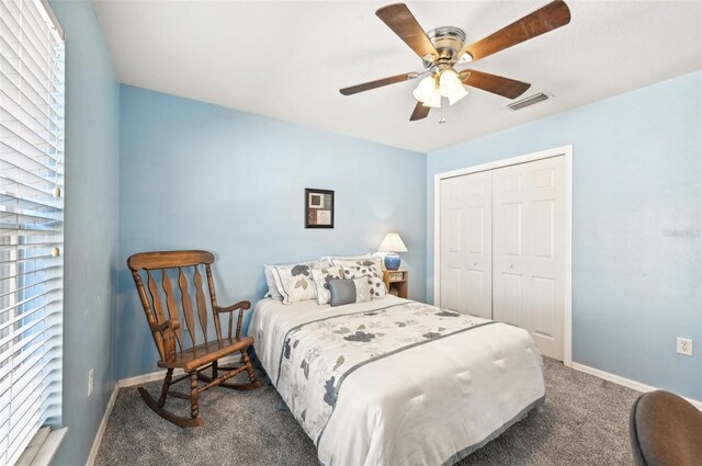 carpeted bedroom featuring a closet and ceiling fan