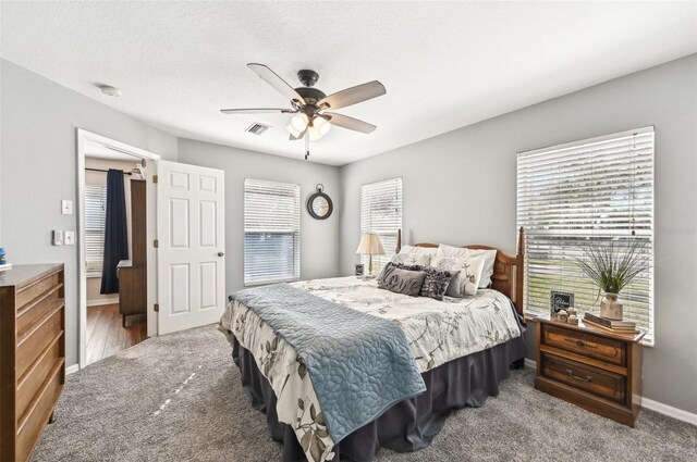 bedroom with carpet flooring, ceiling fan, and a textured ceiling