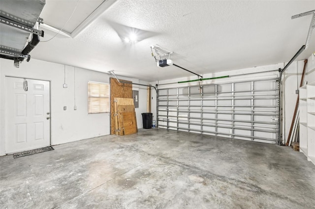 garage featuring electric panel and a garage door opener