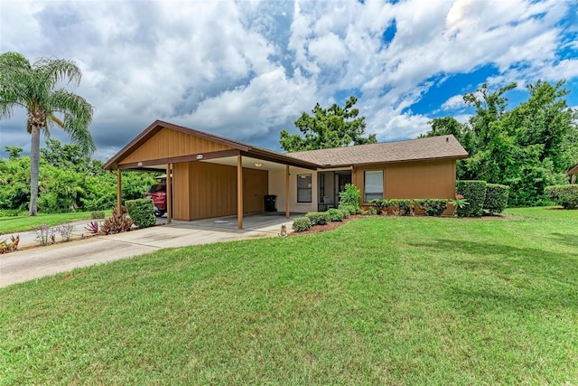 ranch-style home featuring a carport and a front yard