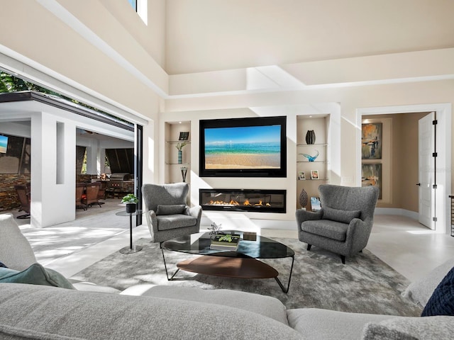 living room with built in features and a towering ceiling