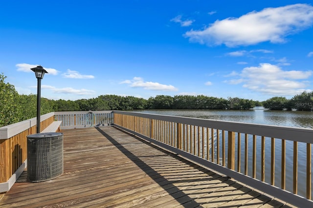 exterior space with central AC and a deck with water view