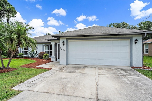 single story home with a garage and a front lawn