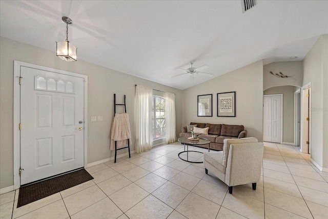 living room featuring light tile patterned flooring, ceiling fan, and vaulted ceiling