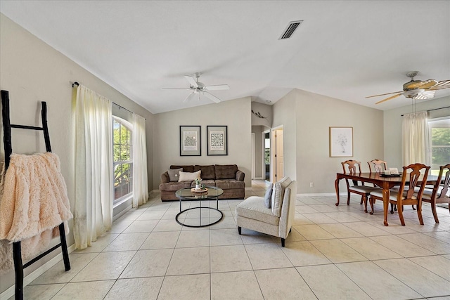 tiled living room featuring a healthy amount of sunlight, lofted ceiling, and ceiling fan