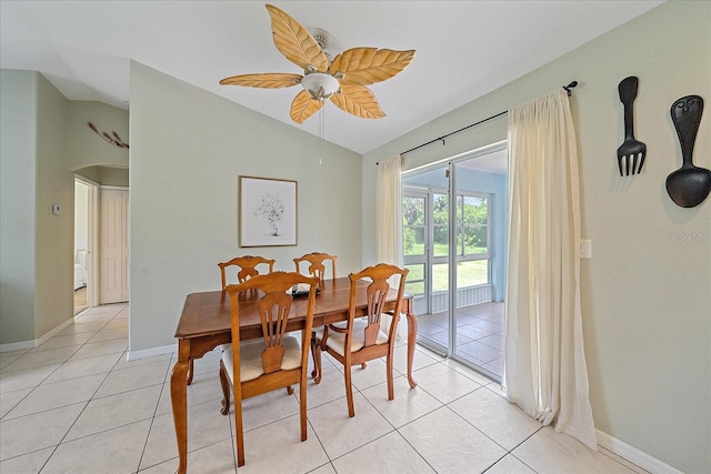 tiled dining area featuring ceiling fan and lofted ceiling