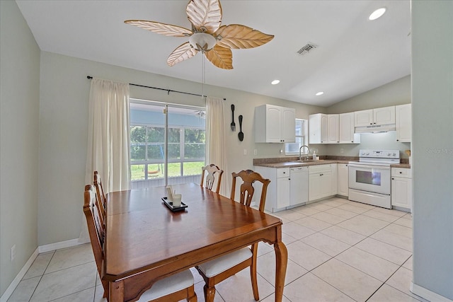 dining space with sink, light tile patterned floors, a healthy amount of sunlight, and ceiling fan