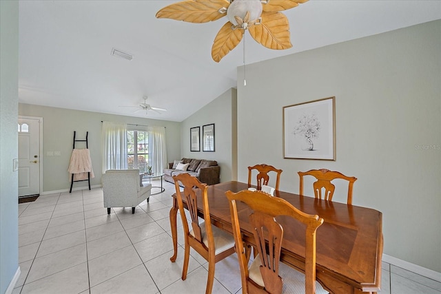 dining area featuring ceiling fan, lofted ceiling, and light tile patterned floors